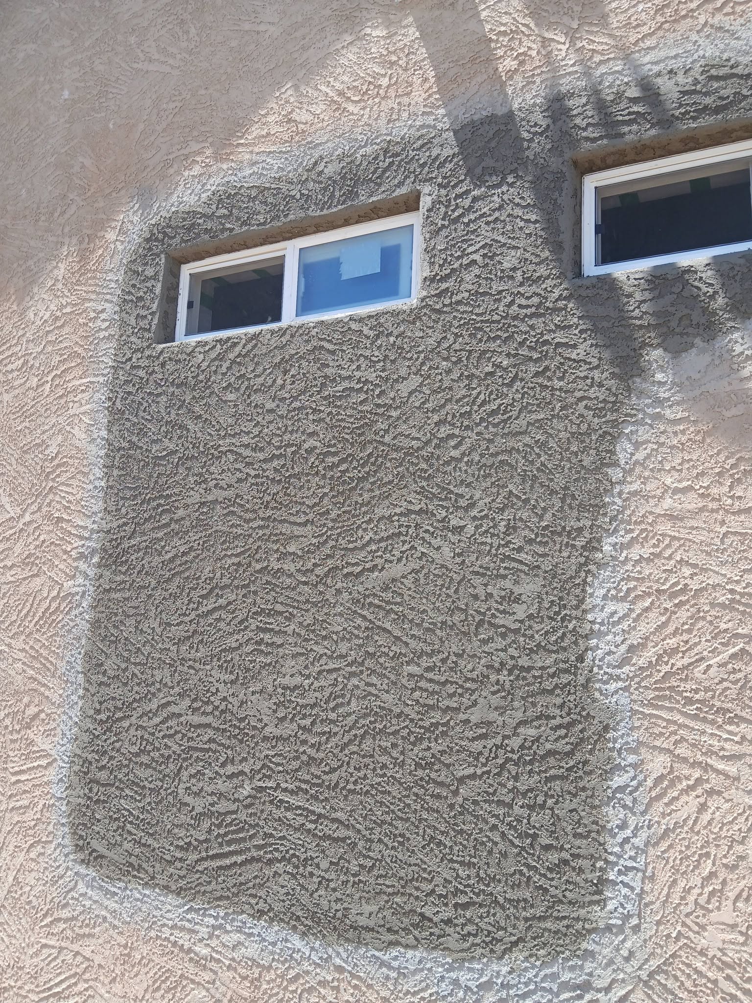 Texture-matched stucco patch ready for color coat on a Las Cruces home