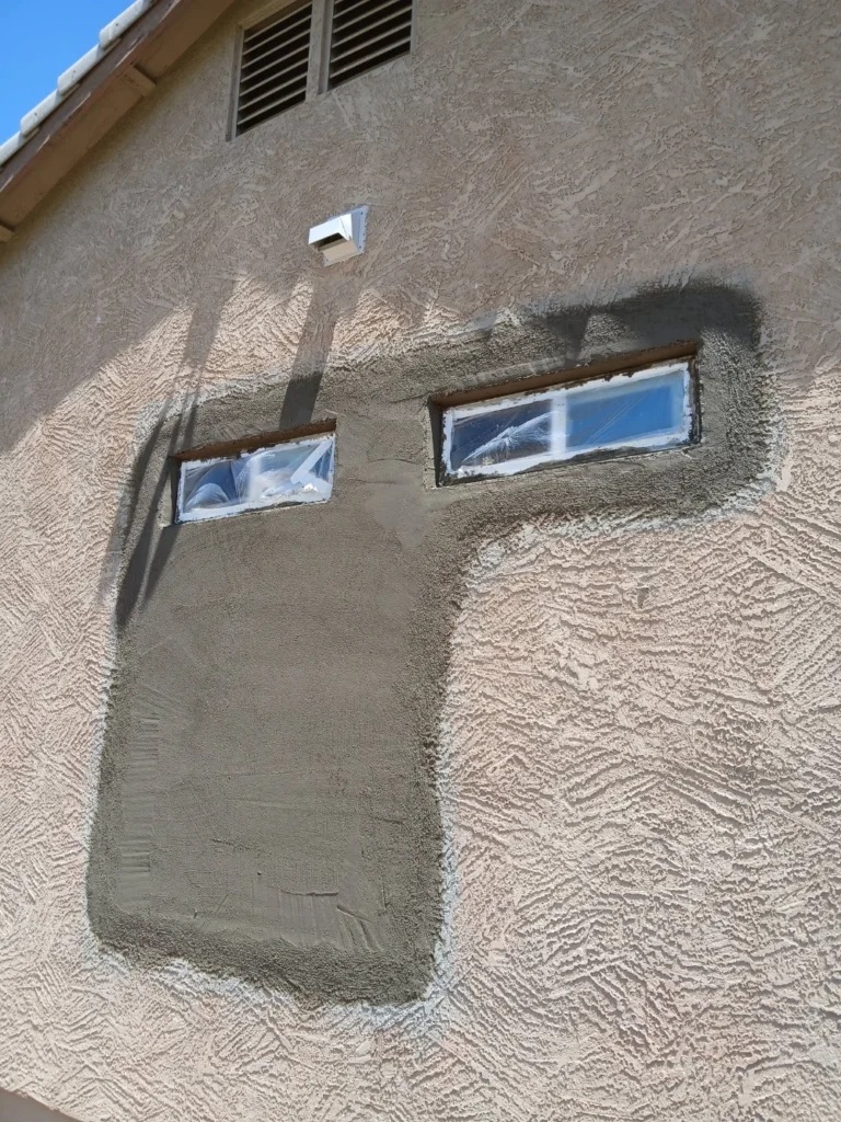 After: scratch coat applied over repaired stucco section in Las Cruces